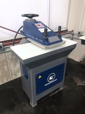 Axis Series swing arm clicker press on its base cabinet