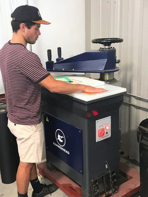 Operator running an Axis Series swing arm clicker press