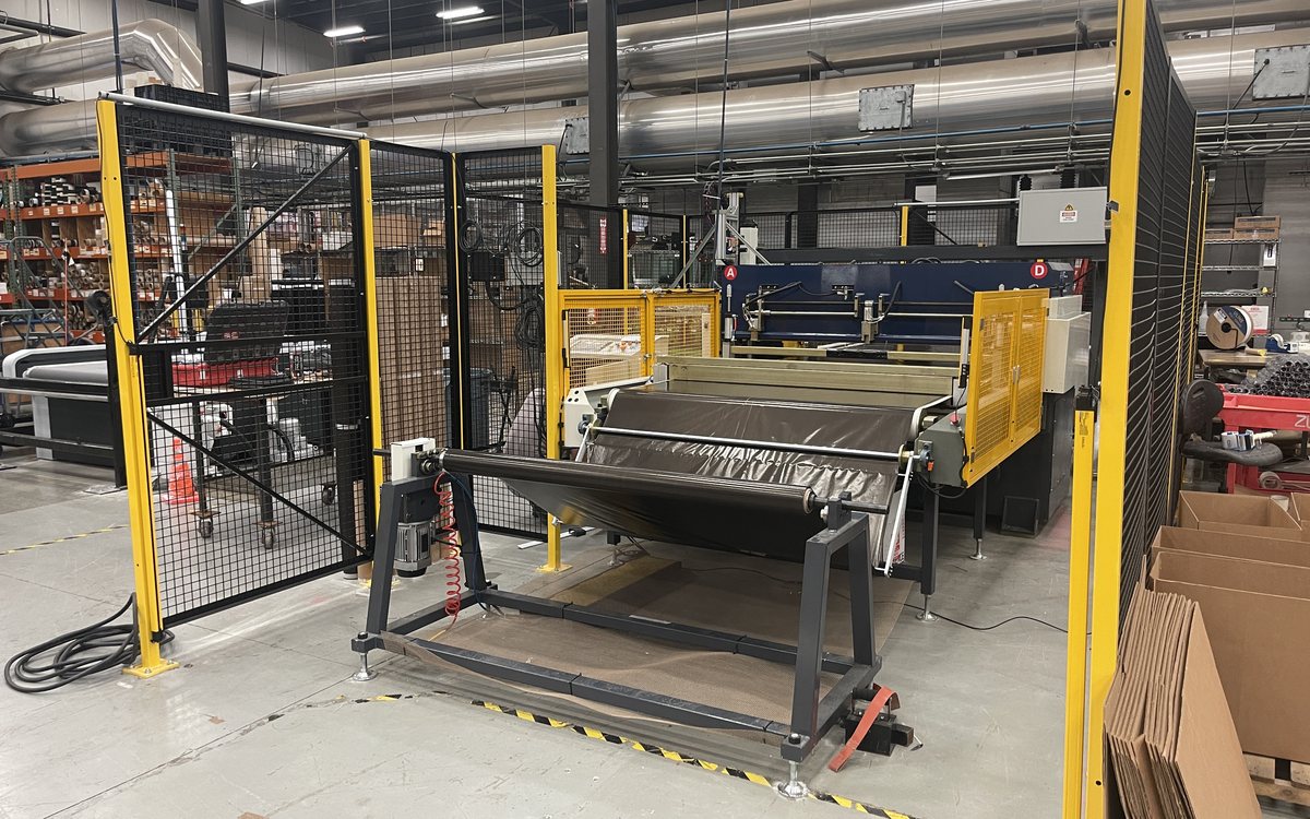 Conveyor-fed die cutting press line on the Payson floor